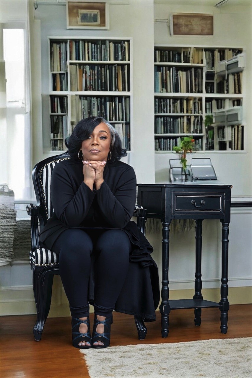 Marsha Holland Kahn seated in a quiet library, dressed in black.